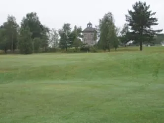 The doocot viewed across its ha-ha near the old oak. The ha-ha is the dip in the golf course fairway that crosses at centre. The golf course has smoothed out and rounded the ha-ha, which can be better seen away from the edges of the fairway.